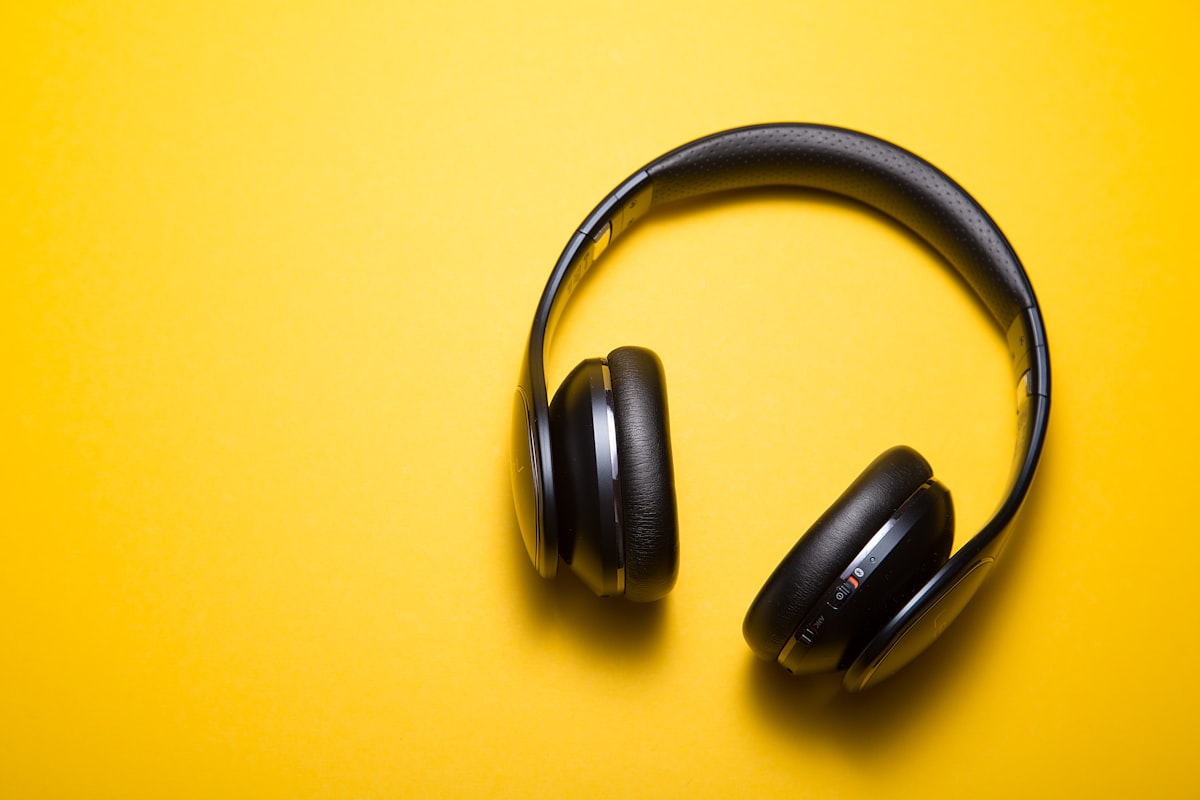 Flat-lay of wireless headphones on a plain background